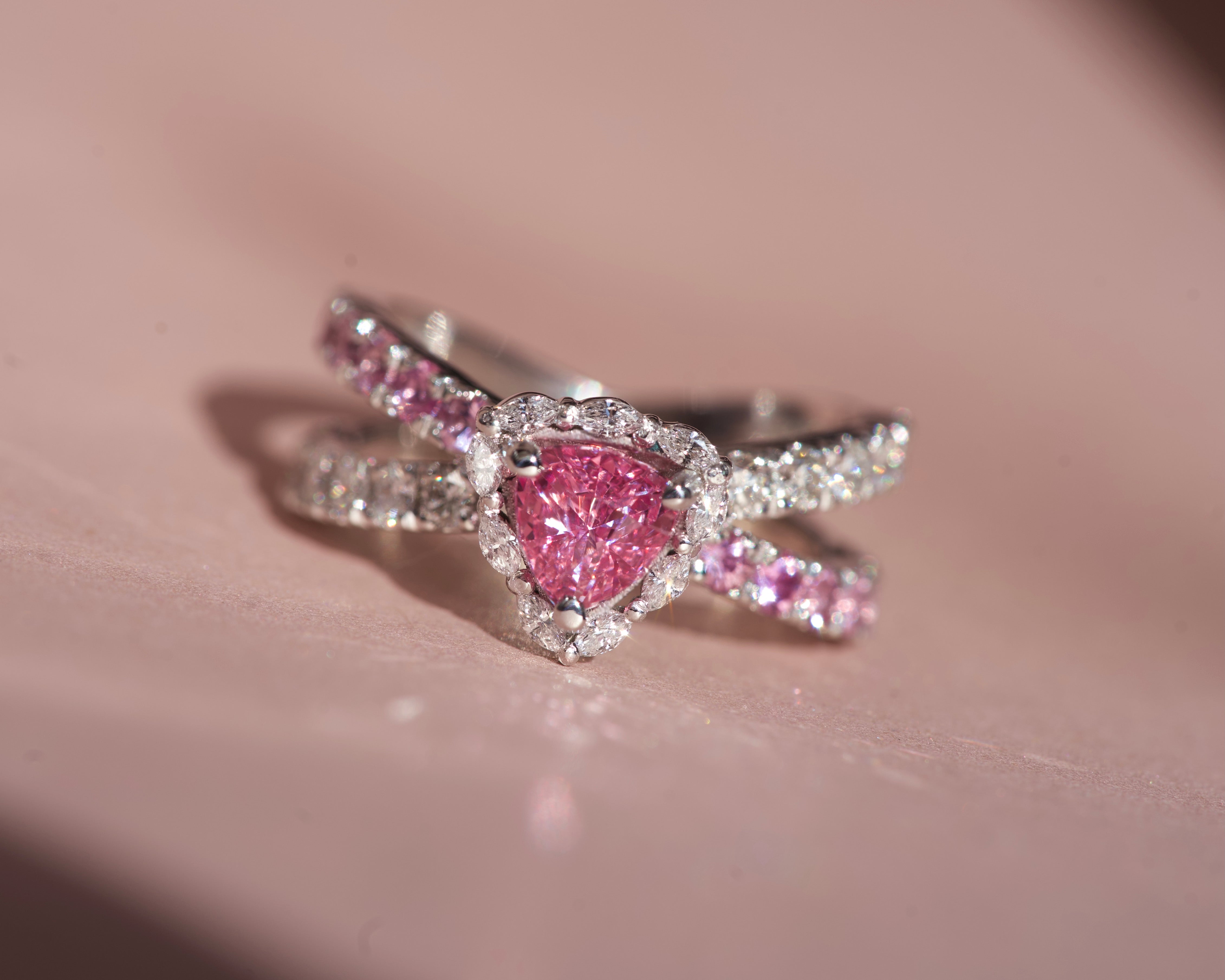 Close-up of a 1.10ct unheated Ceylon pink sapphire ring with a trillion diamond halo