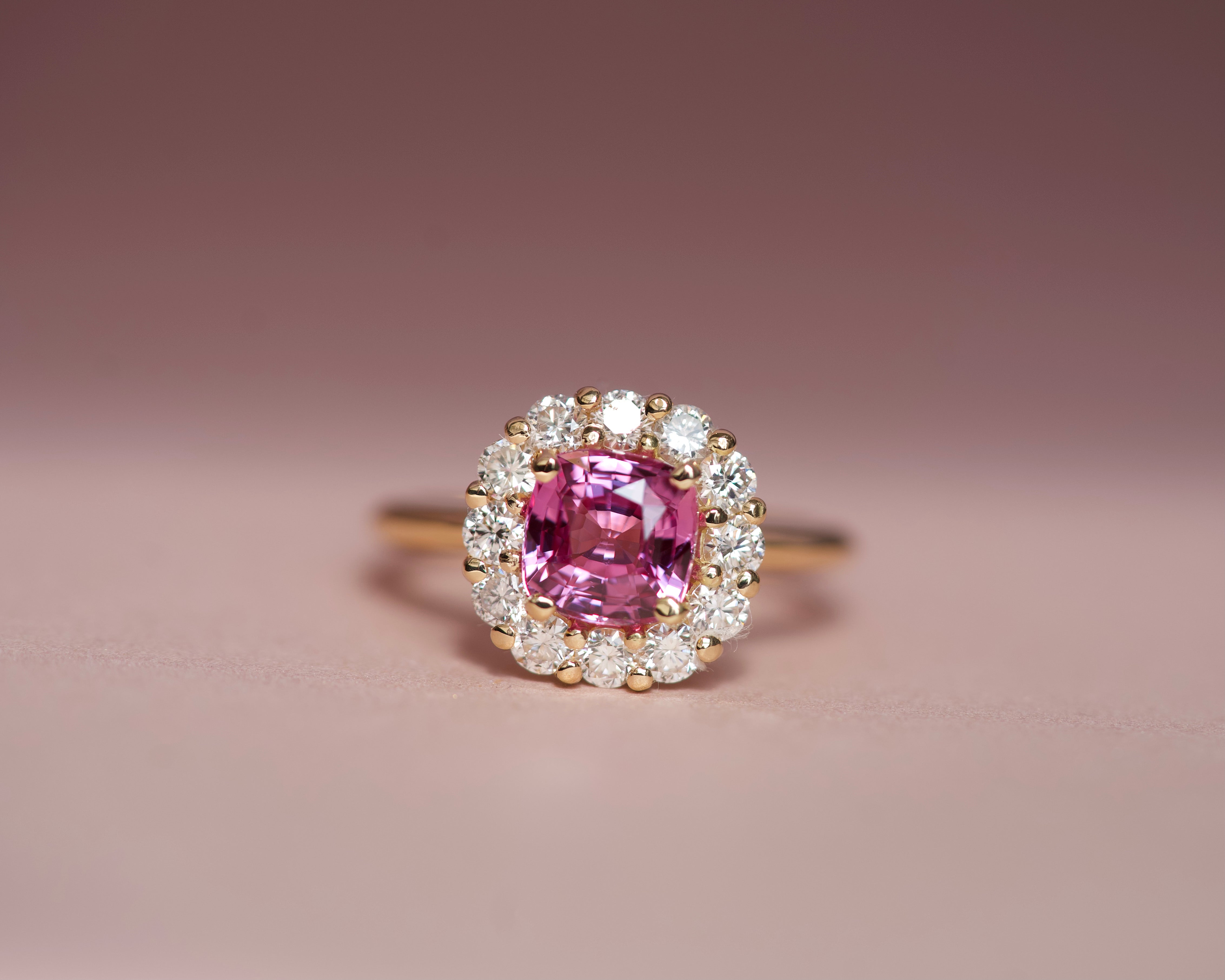 Pink sapphire cushion cut ring with diamond halo