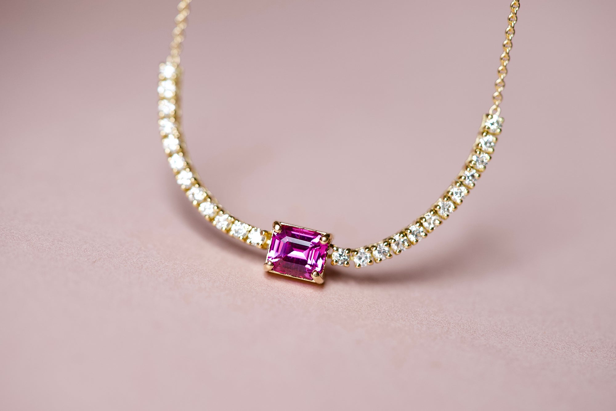 Pink sapphire centerpiece on diamond tennis necklace