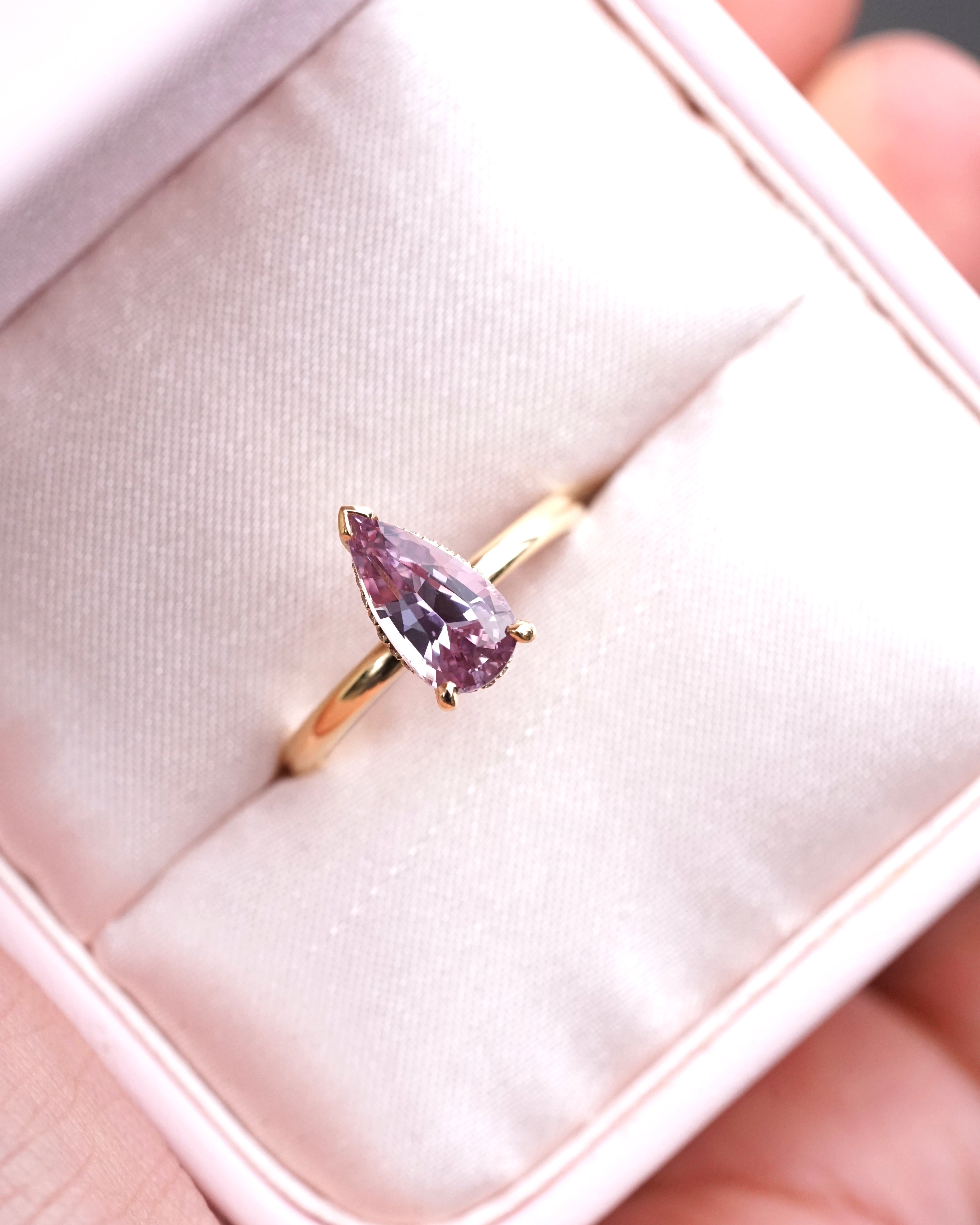 Pear shaped pink sapphire engagement ring in yellow gold