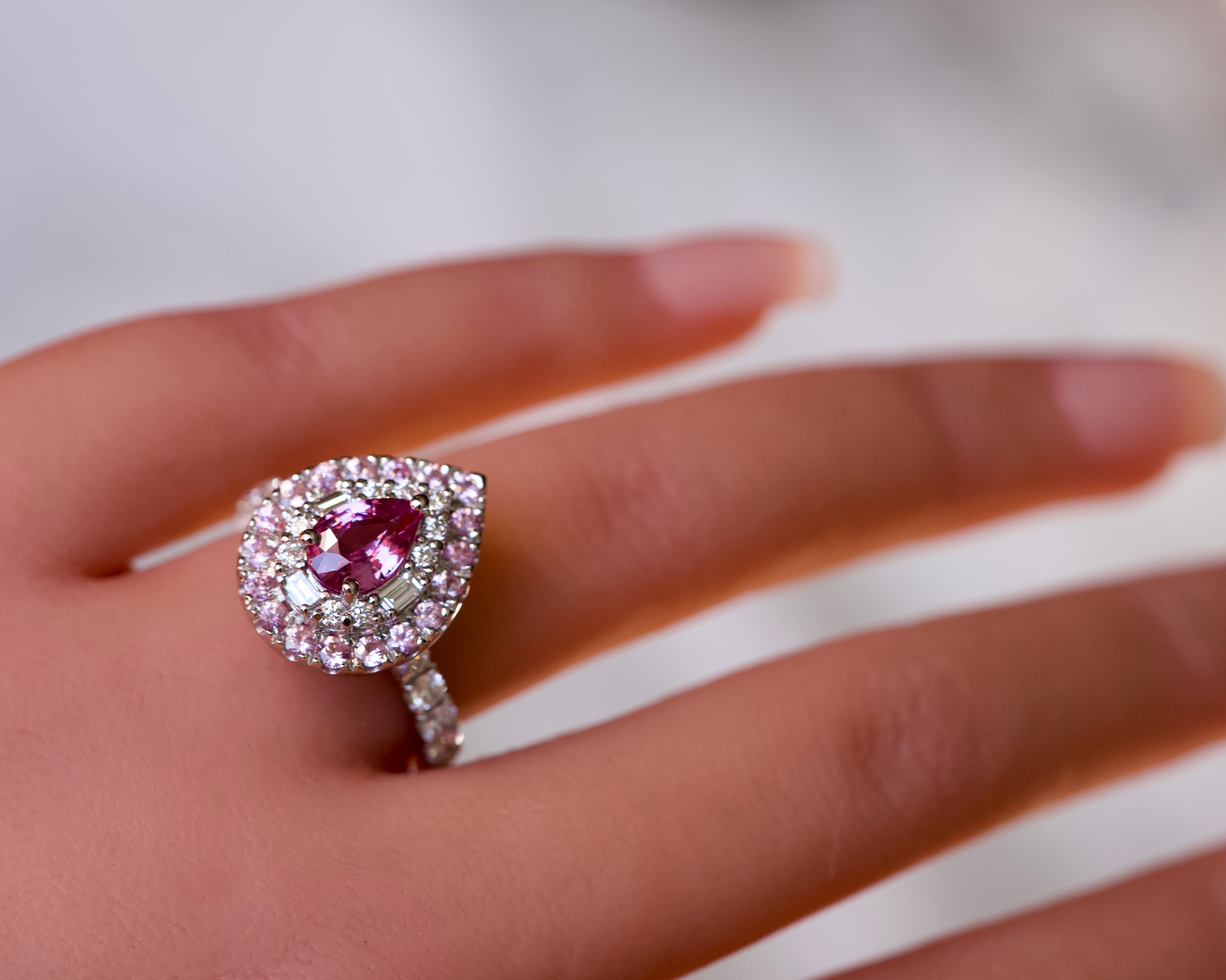 Side view of a custom pink sapphire double halo ring in platinum highlighting the diamond band