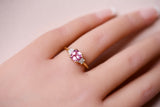 Pink sapphire three stone ring worn on hand