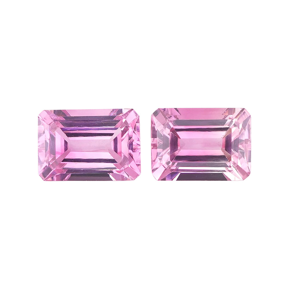 Two intense candy pink rectangular step-cut matched gemstones side by side.
