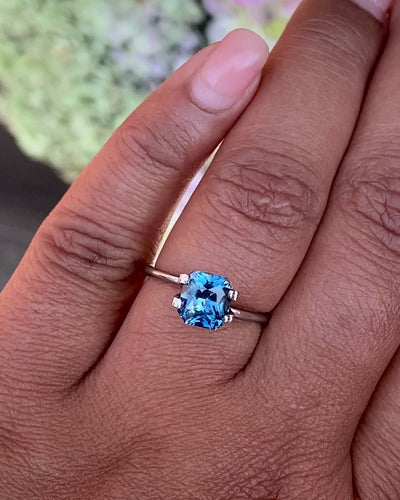 on hand teal natural sapphire in radiant cut