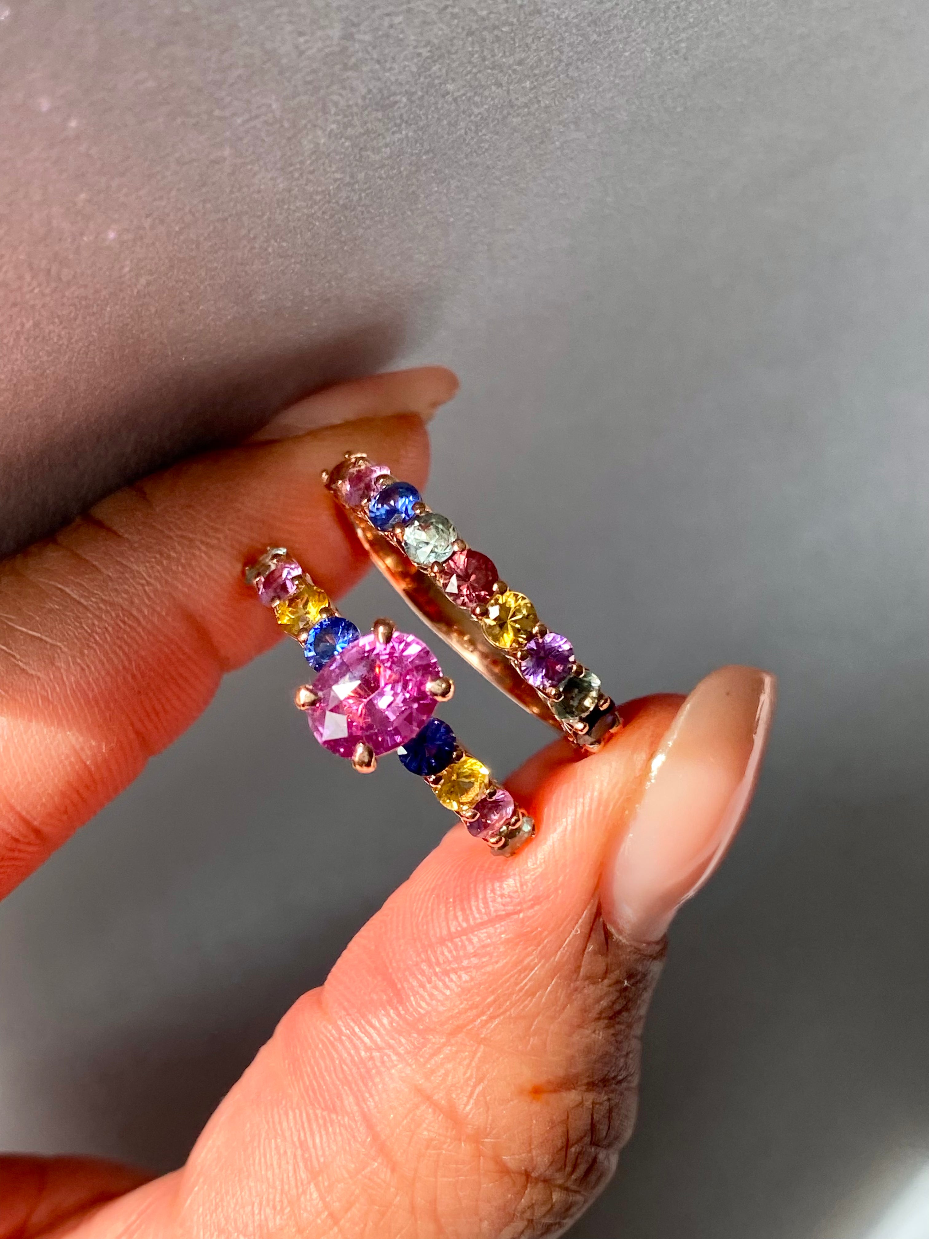 Rainbow sapphire band stacked with pink sapphire ring