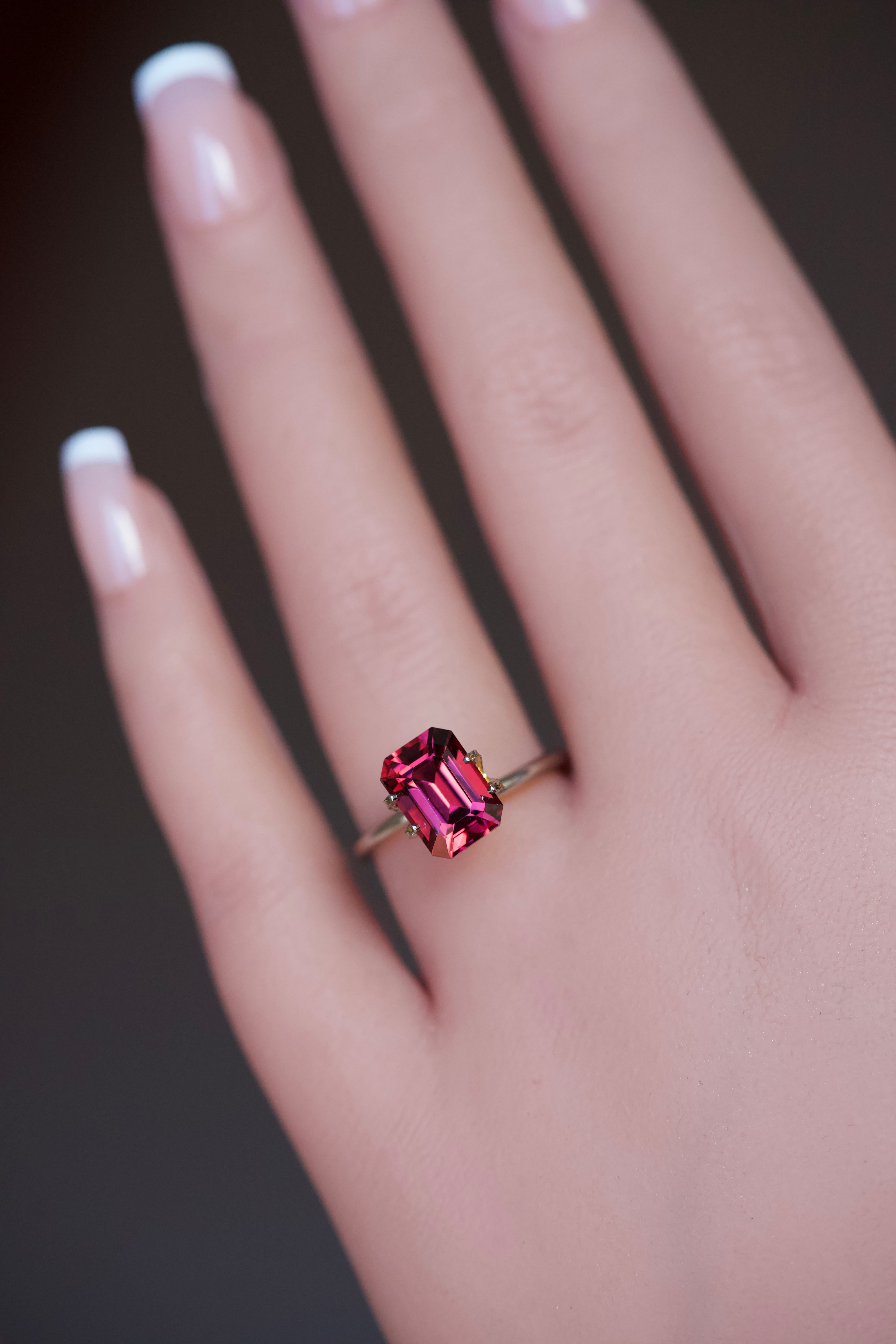 A model wearing a vibrant purplish pink garnet mockup ring.