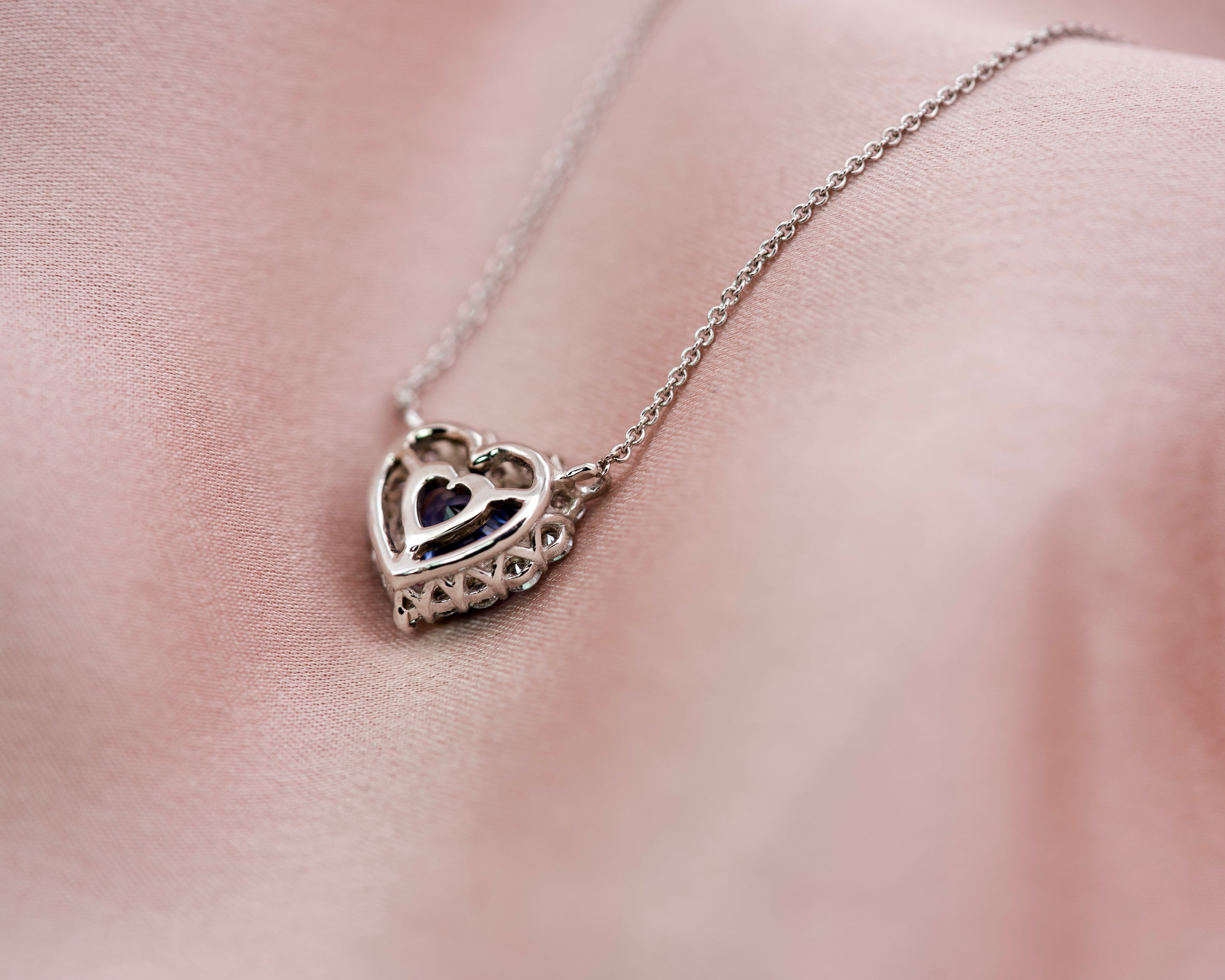 Reverse view of a sapphire heart pendant illustrating the intricate white gold basket work