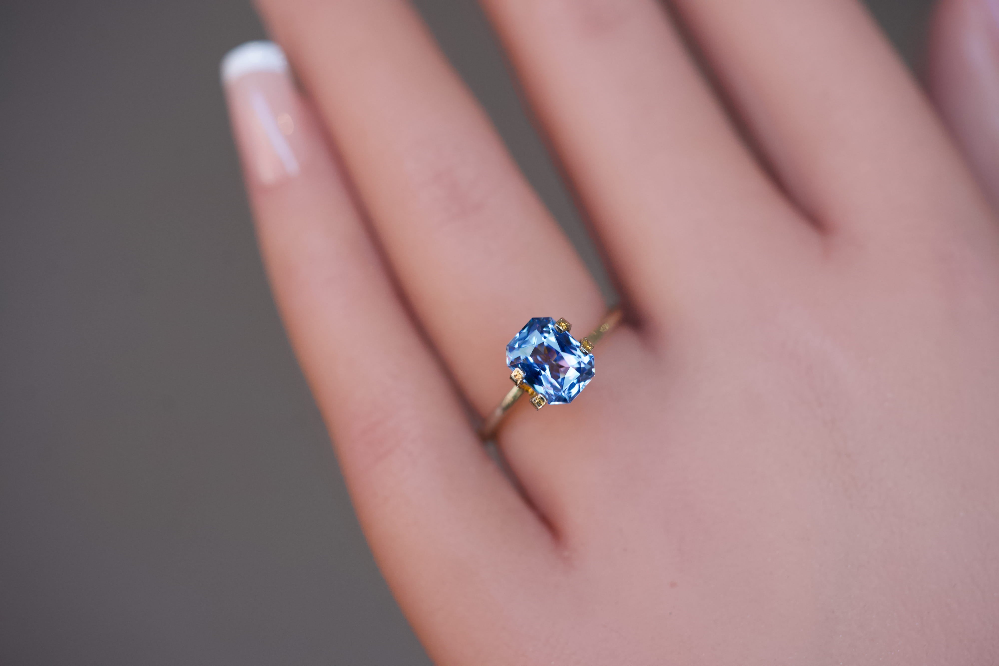 Detailed view of a natural blue Ceylon octagonal sapphire resting in a temporary ring setting.