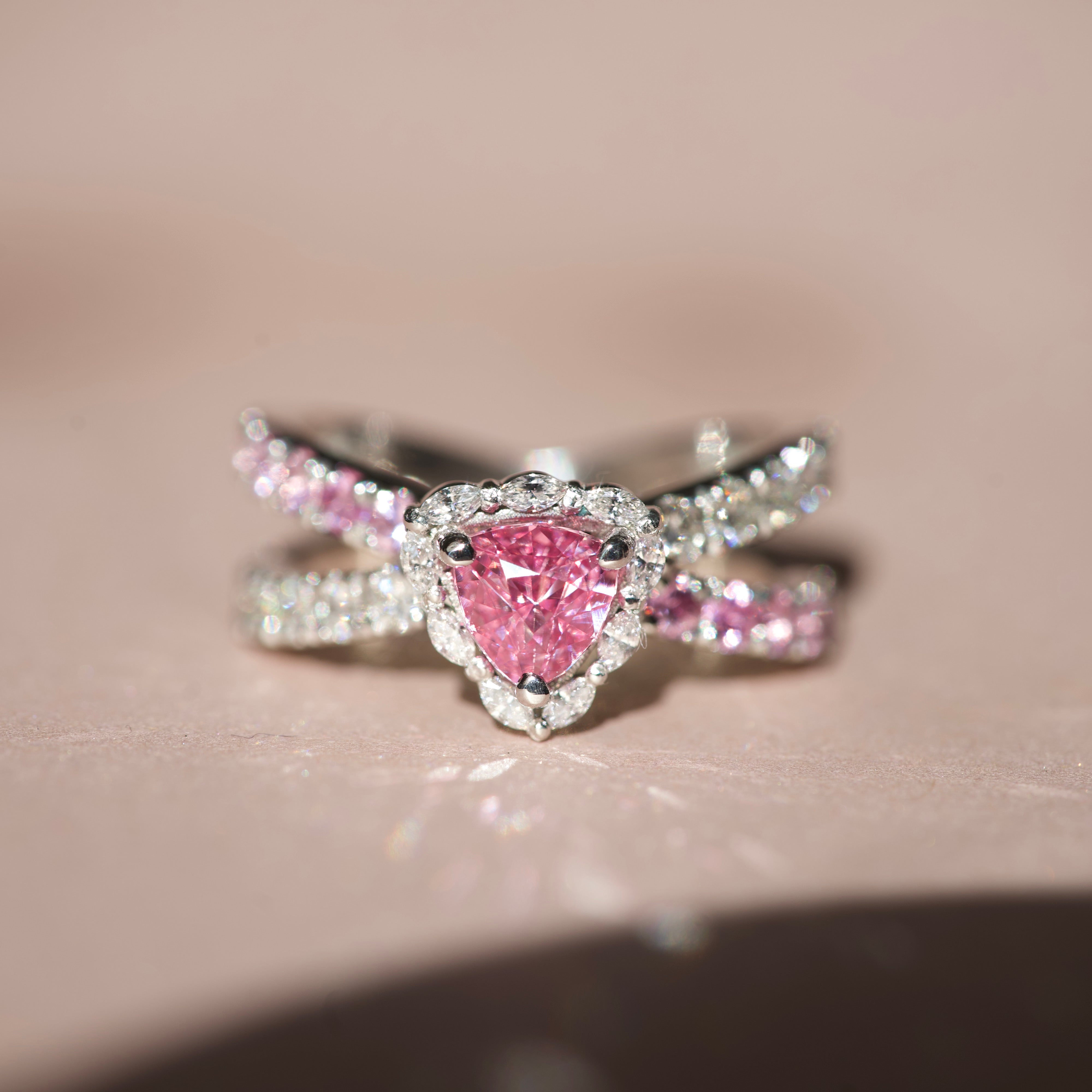 Close-up of a 1.10ct unheated Ceylon pink sapphire ring with a trillion diamond halo